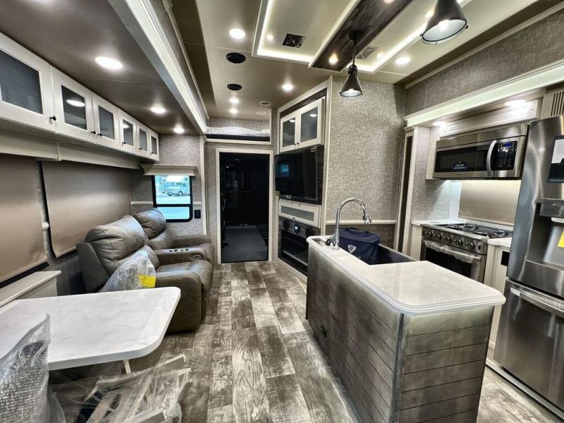 Kitchen and living room in the Vanleigh Ambition toy hauler fifth wheel